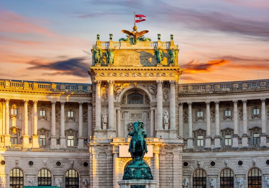 Vienna: Skip-the-Line Sisi Museum, Hofburg and Gardens Tour - Entering the Hofburg Palace in the Michaelerplatz area