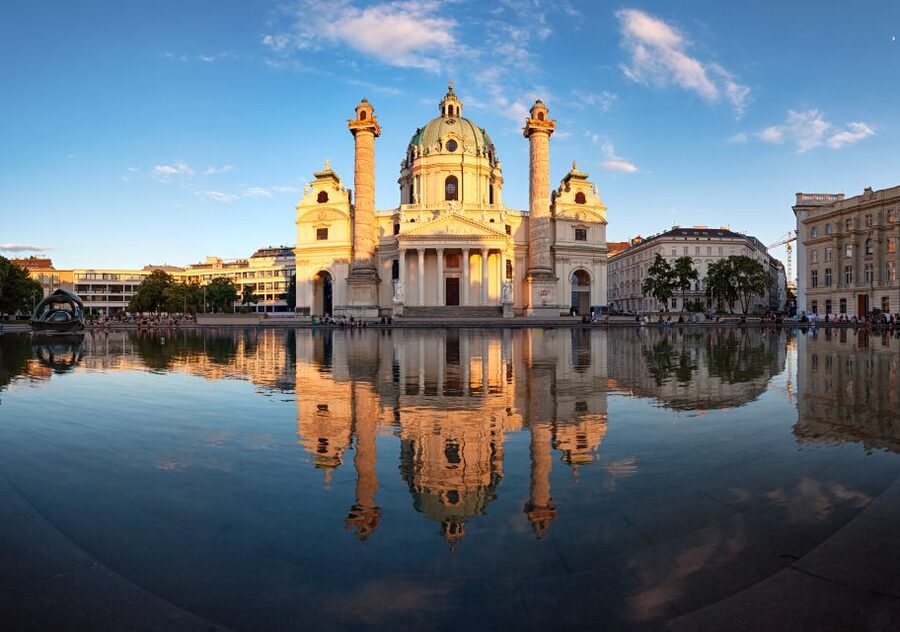 Karlskirche lit at dusk above its reflecting pool, Vienna